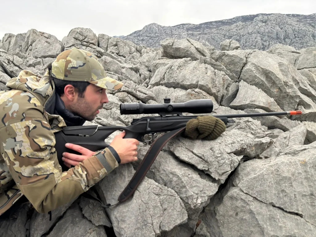 Client of Artemis Hunting aiming at a mouflon in Croatia with Blaser R8 300WM rented rifle from Artemis Hunting